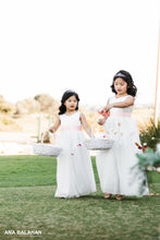 Load image into Gallery viewer, Two flower girls walking down the aisle throwing petals