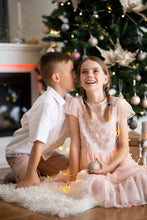 Load image into Gallery viewer, Ana Balahan Boy in white cotton linen shirt and shorts and girls sitting and whispering under the Christmas tree Australia