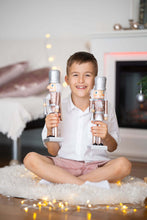 Load image into Gallery viewer, Ana Balahan Boy in white cotton linen shirt and shorts sitting with Christmas toys Sydney