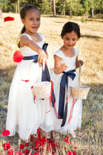 Load image into Gallery viewer, Annabelle dress Ana Balahan Two cute flower girls in Annabelle dresses with navy sashes throwing red petals