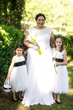 Load image into Gallery viewer, Bride with two flower girls in Adelina white color dresses with wave edge and black color sashes Ana Balahan