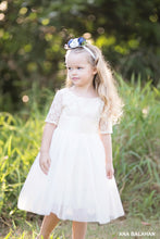 Load image into Gallery viewer, Girl in medium length Sofia champagne lace flower girl dress with flower headpiece