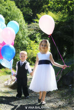 Load image into Gallery viewer, Girl in Adelina dress with a page boy on a walk with baloons