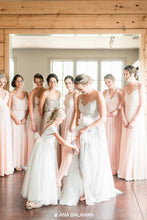 Load image into Gallery viewer, Flower girl in Annabelle dress adjusting bride's garter