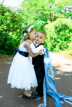 Load image into Gallery viewer, Girl in Adelina dress hugs a page boy