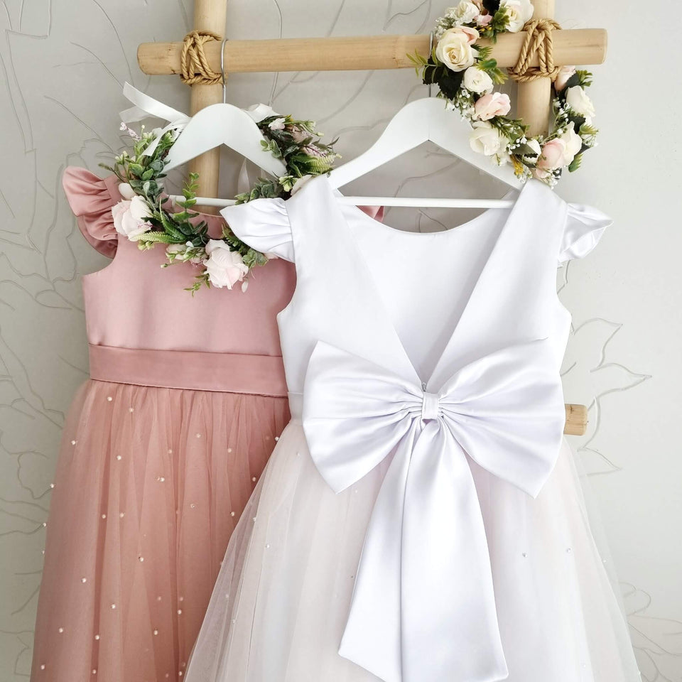 Modern formal dresses with open back and big bows in white and mauve colors