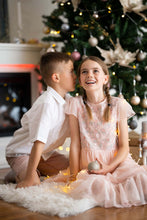 Load image into Gallery viewer, Ana Balahan Boy in white cotton linen shirt and shorts and girls sitting and whispering under the Christmas tree Australia
