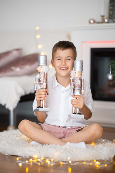 Ana Balahan Boy in white cotton linen shirt and shorts sitting with Christmas toys Sydney