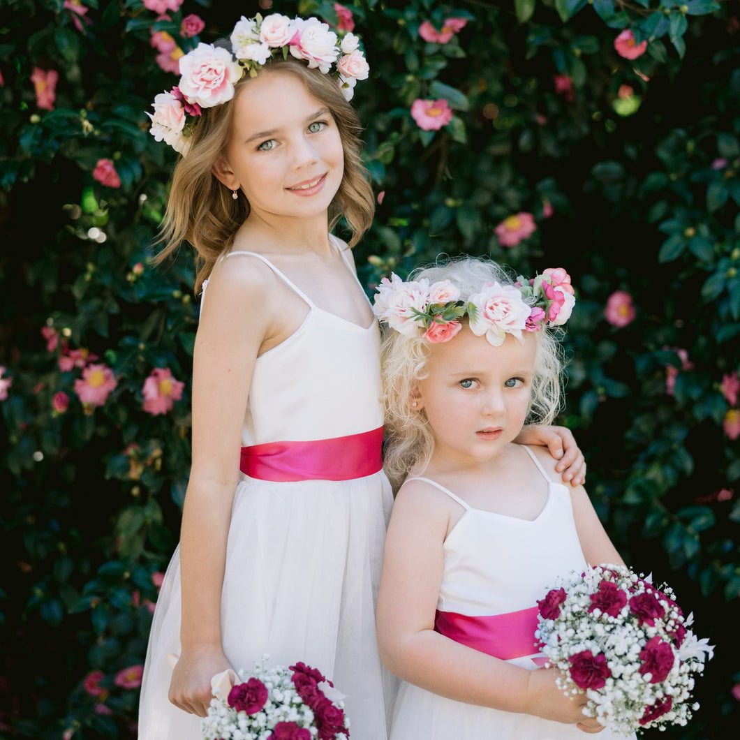 Ana Balahan Two pretty girls in a park wearing Scarlett flower girl dresses and holding wedding flowers Australia