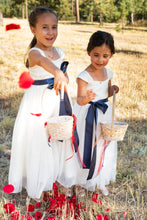 Load image into Gallery viewer, Annabelle dress Ana Balahan Two cute flower girls in Annabelle dresses with navy sashes throwing red petals
