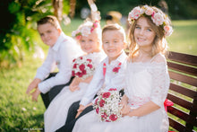 Load image into Gallery viewer, Flower girls and page boys in their special occasion outfits with floral wreath and bouquets. Beautiful garden wedding.
