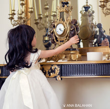 Load image into Gallery viewer, Girl in Annabelle dress looking at a fancy watch
